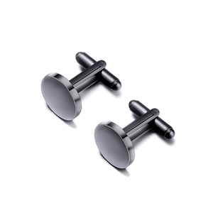 Detailed view of polished black circular stainless steel cufflinks with T-clasp