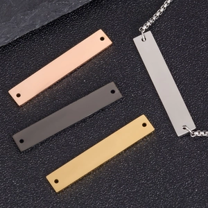 Detailed macro view of rectangular stainless steel tags in four colors for DIY jewelry