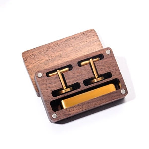 Golden cufflinks and tie clip set presented in a premium walnut wooden gift box with magnetic lid