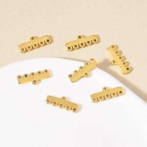 Macro view of golden multi-hole stainless steel connectors for DIY jewelry making