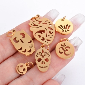 Polished stainless steel gold pendants featuring heart, skull, owl and lotus designs