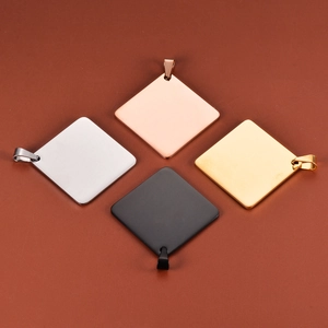 Detail of square titanium steel tags in silver, gold, rose gold, and black mirror finish