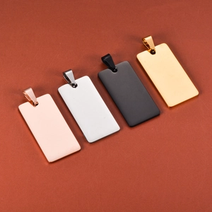 Detail view of four rectangular stainless steel tags in gold, silver, rose gold and black