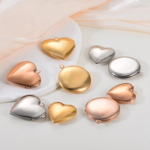 Macro view of mirror polished heart and round locket pendants on satin fabric