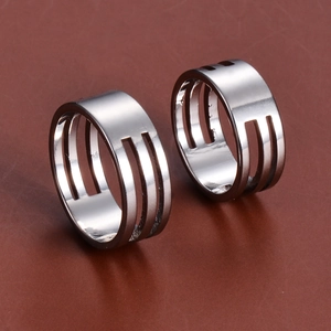 Pair of minimalist stainless steel wide rings with triple open line design on leather base