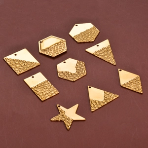 Detailed view of geometric stainless steel jewelry charms with textured and polished finishes