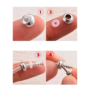 Detail of inserting a silicone ring into a stainless steel bead for DIY jewelry making