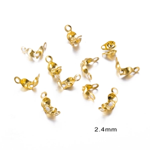 Close-up of 2.4mm gold-plated crimp covers and calotte connectors for DIY jewelry making