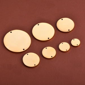Detailed view of assorted mirror polished gold stainless steel double hole round charms