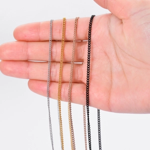 Detail of four stainless steel curb chains in silver, gold, rose gold, and black colors