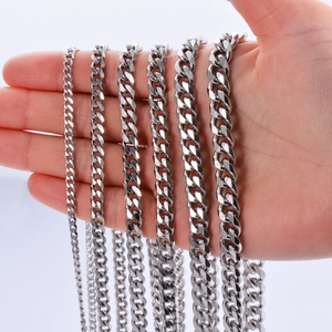 Multiple widths of polished stainless steel Cuban link chains shown in a hand for comparison
