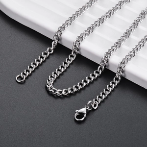 Detail of a minimalist silver stainless steel curb chain with a durable lobster clasp