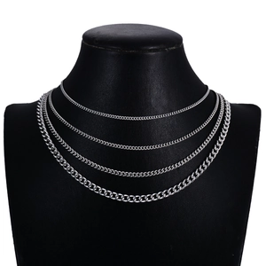 Silver stainless steel layered necklace set featuring four curb chains on a black bust display