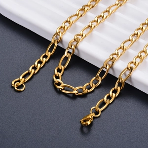 Polished gold Figaro chain necklace with lobster clasp on minimalist display stand
