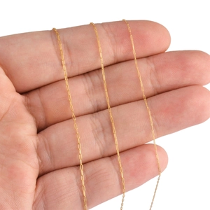 Polished gold paperclip chain link necklace held by hand to show size and scale