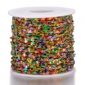 Colorful enamel bead gold chain on white spool for DIY jewelry making and necklace crafts