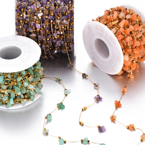 Detail of colorful natural stone beads with gold metal cubes on DIY stainless steel chains