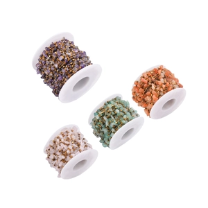 Macro view of four colorful natural gravel bead chains for DIY jewelry making