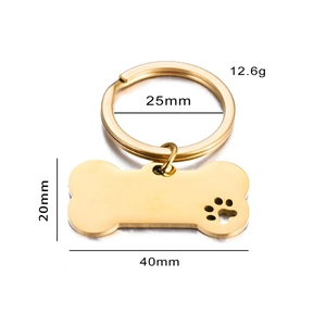 Polished gold bone-shaped stainless steel pet tag with hollow paw print and 25mm ring