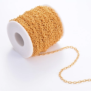 Golden stainless steel cross textured chain on white spool for DIY necklace making