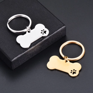 Polished stainless steel bone-shaped pet ID tags with hollow paw cutout in gold and silver