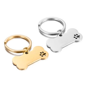 Polished stainless steel bone shaped dog tag with hollow paw print in gold and silver