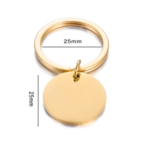 Close-up of 25mm polished golden stainless steel round dog tag and flat keyring