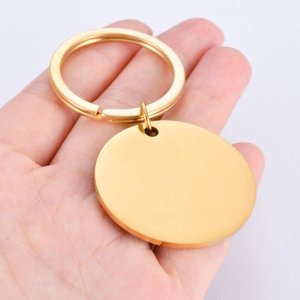 Golden round mirror polished stainless steel keychain pendant on a flat metal split ring