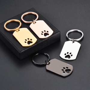Polished stainless steel paw print keychains in gold, rose gold, silver, and gunmetal finishes