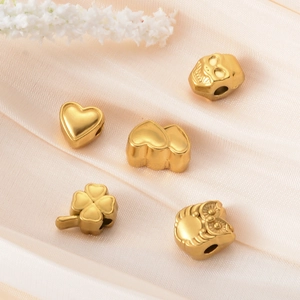 Matte gold stainless steel spacer beads in heart, skull, and owl shapes for DIY jewelry