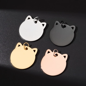 Cat head shaped metal pet ID tags in four colors for DIY engraving on black background