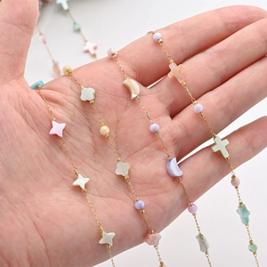 Colorful shell stainless steel chain featuring star moon cross and clover charms on hand