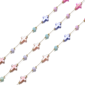 Detail of gold chain with colorful mother of pearl crosses and pastel beads