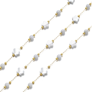 Close-up of 18k gold chain with shell stars and translucent blue circular beads