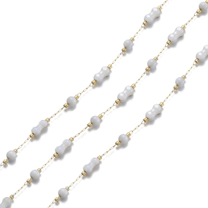 Detail of 18k gold chain with elegant white dumbbell and round shaped shell beads