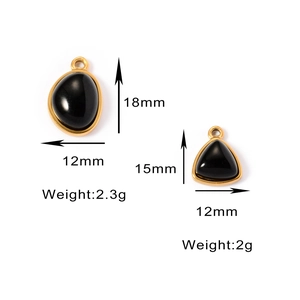Detailed view of geometric gold stainless steel pendants with black natural stone inlays