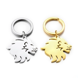 Detailed view of laser-cut lion head keychains in polished gold and silver finishes