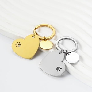 Polished stainless steel heart keychain with hollow paw print and blank tag in gold and silver