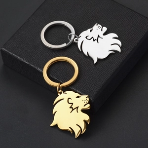 Polished lion head keychains in silver and gold stainless steel on jewelry box