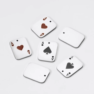 Macro view of polished stainless steel Ace of Hearts and Spades poker card pendants