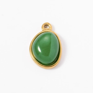 Detail of a luxury oval green natural stone pendant with a polished gold stainless steel frame
