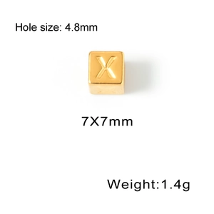 Detailed view of a 7mm golden titanium steel square bead with engraved letter X
