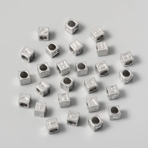 Detailed view of silver stainless steel 7mm square letter beads for DIY jewelry making
