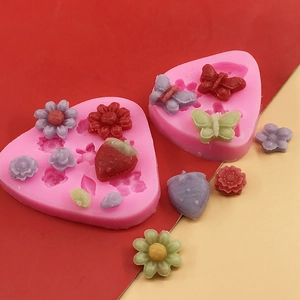 Pink silicone mold for flowers and butterflies used for fondant, clay, and resin crafts