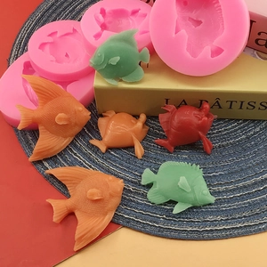 Silicone fish mold set for fondant and chocolate cake decorating on a blue mat