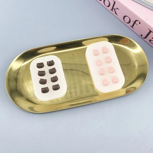 Mini silicone molds for cartoon cat and bunny shapes on a golden tray