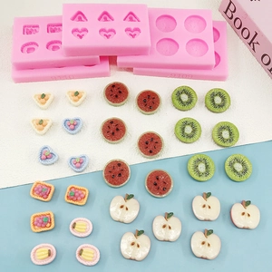 Pink silicone fruit molds for fondant and chocolate featuring watermelon and kiwi shapes