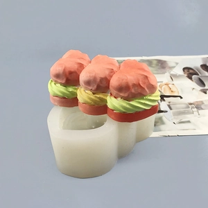 Detailed view of 3-cavity heart silicone mold with multilayered dessert resin models