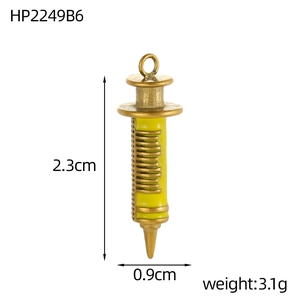 Macro view of vintage gold syringe pendant with yellow enamel inlay and dimensions