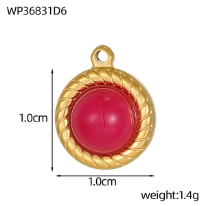Detailed view of a 1cm round red natural stone pendant in gold rope-textured steel frame